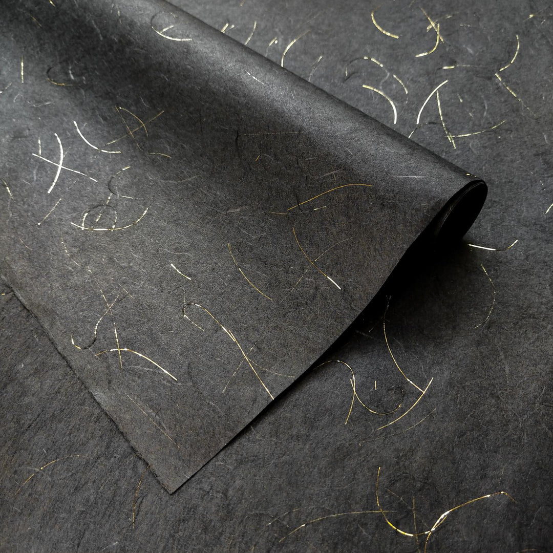 Detailed view of Golden Tinsel Unryu Kozo paper from Kozo Studio, highlighting the elegant black mulberry paper and shimmering gold fibers embedded in its handmade texture.