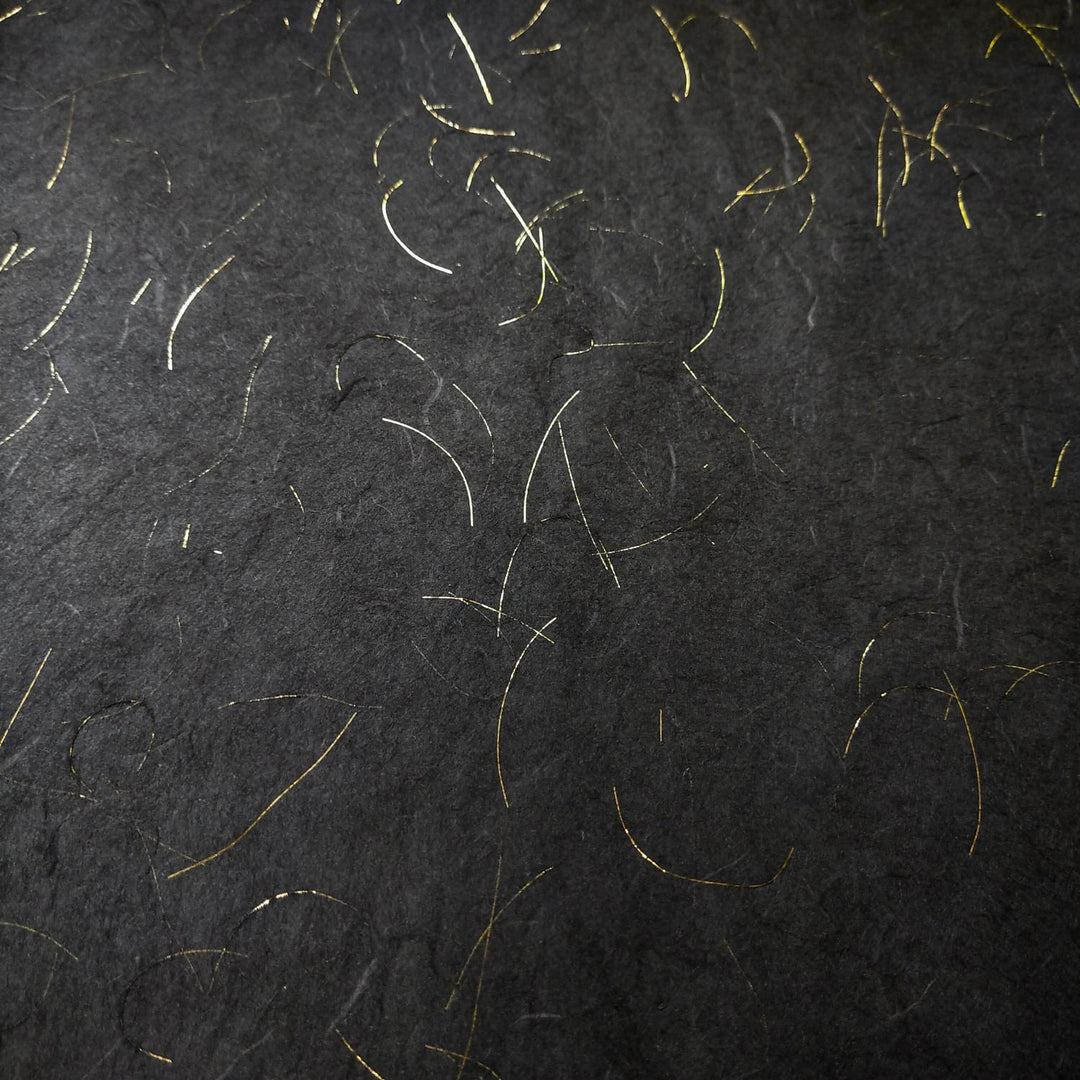 Kozo Studio Golden Tinsel Unryu handmade paper in black, crafted from mulberry paper with fine gold strands and a subtle, organic pattern.