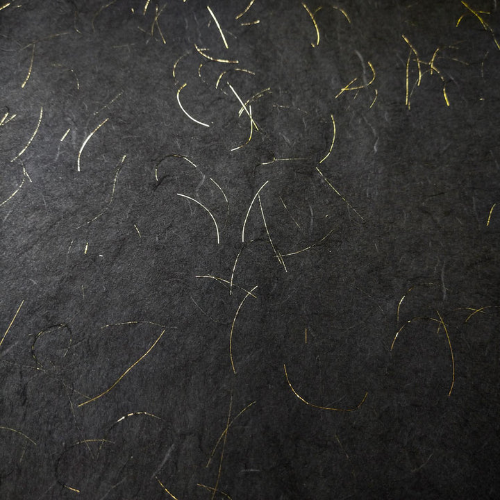 Kozo Studio Golden Tinsel Unryu handmade paper in black, crafted from mulberry paper with fine gold strands and a subtle, organic pattern.