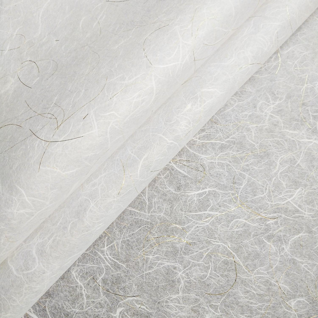 Close-up of Golden Tinsel Unryu mulberry paper by Kozo Studio featuring white handmade paper with gold accents and translucent wispy fibers