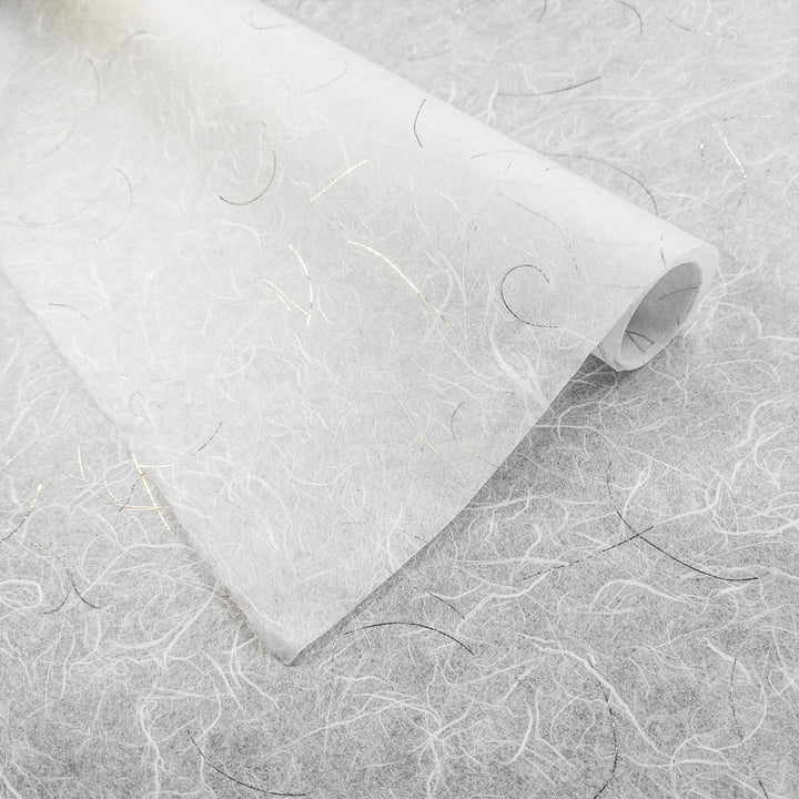 Handmade mulberry paper from Kozo Studio with delicate gold threads and a lightweight, ethereal texture on a white Unryu background