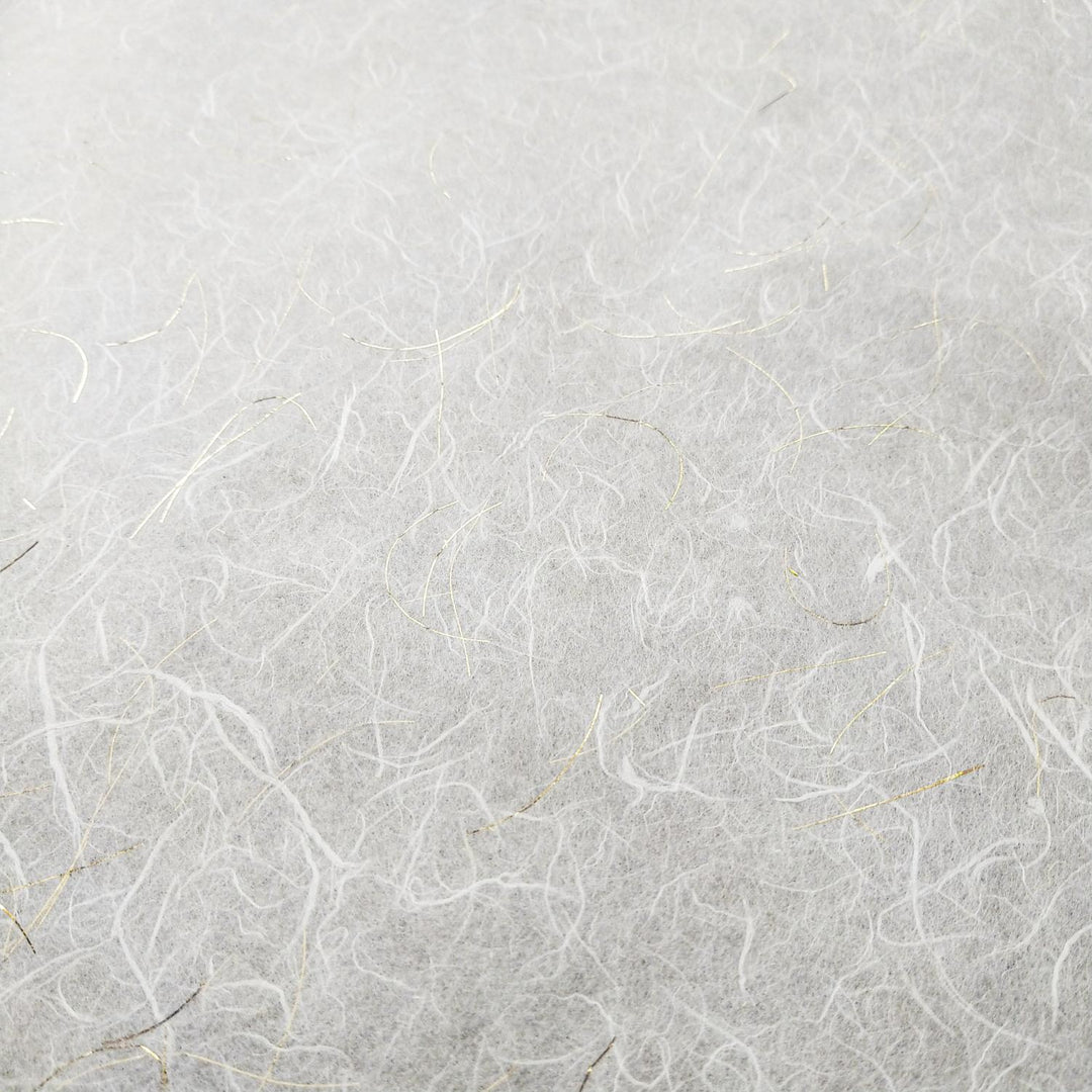 Kozo Studio handmade paper showcasing white Unryu mulberry paper with shimmering gold highlights and organic fiber patterns