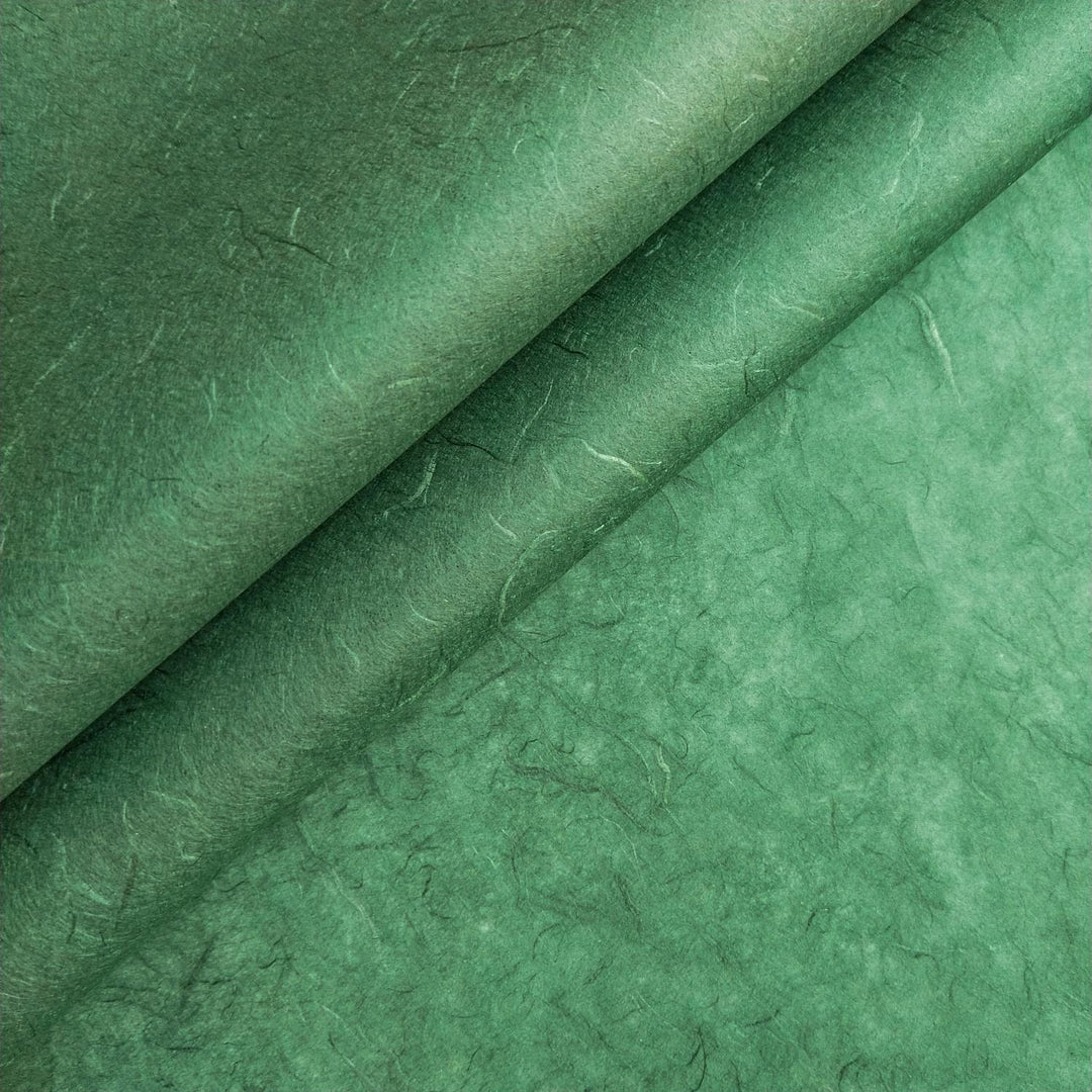 Close-up of Amazon Green Unryu mulberry paper by Kozo Studio showing visible fibers and textured surface, highlighting the natural beauty of handmade paper.