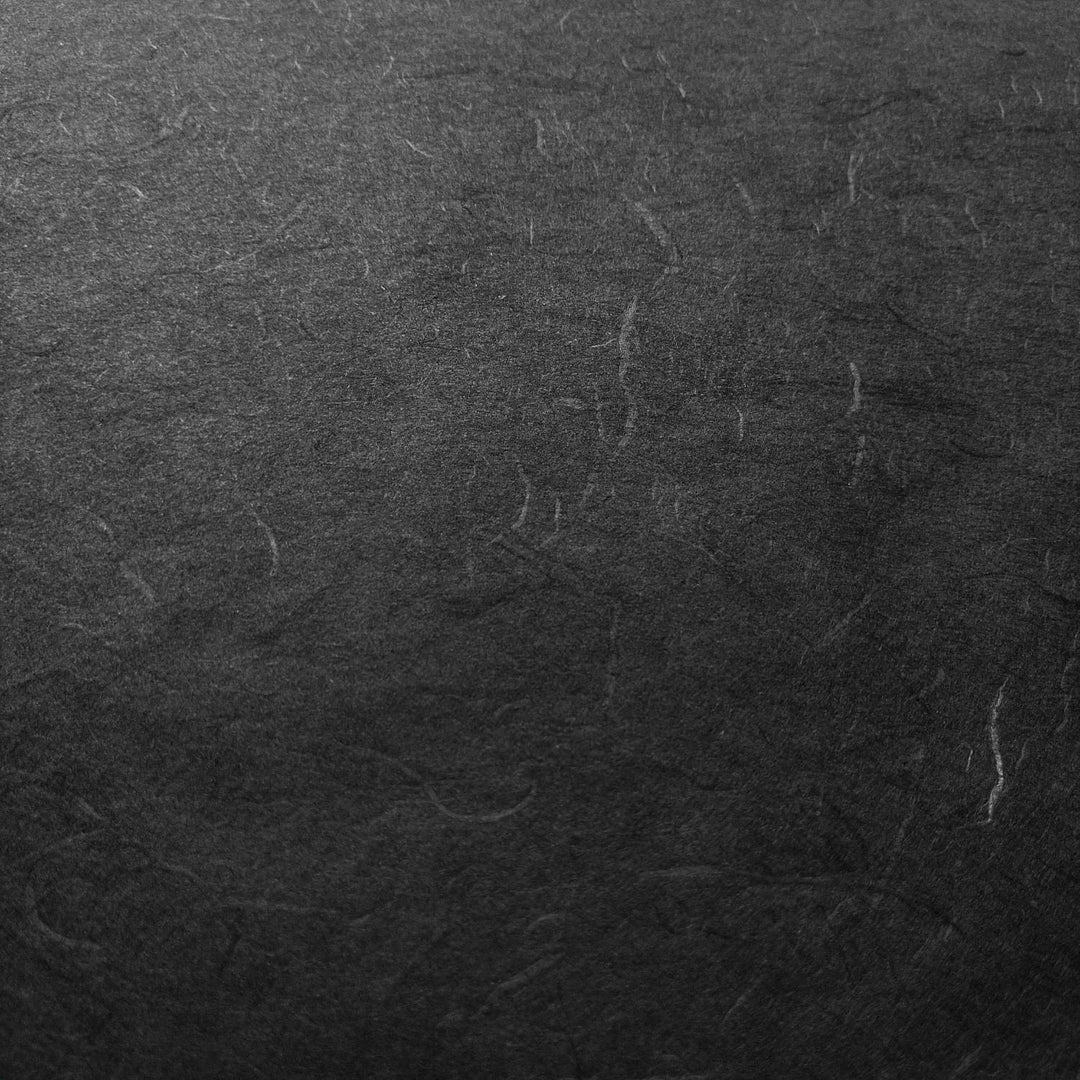 Elegant and rough-surfaced black mulberry paper by Kozo Studio, featuring signature Unryu texture typical of handmade paper.