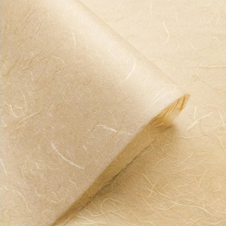 Kozo Studio handmade paper in a beach sand shade, highlighting the unique fibers and delicate fold of premium mulberry paper.