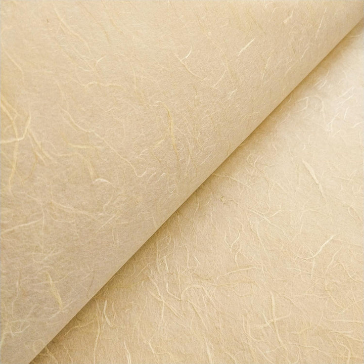 Beige mulberry paper from Kozo Studio with a textured surface and visible fibers, exemplifying the handcrafted quality of handmade paper.