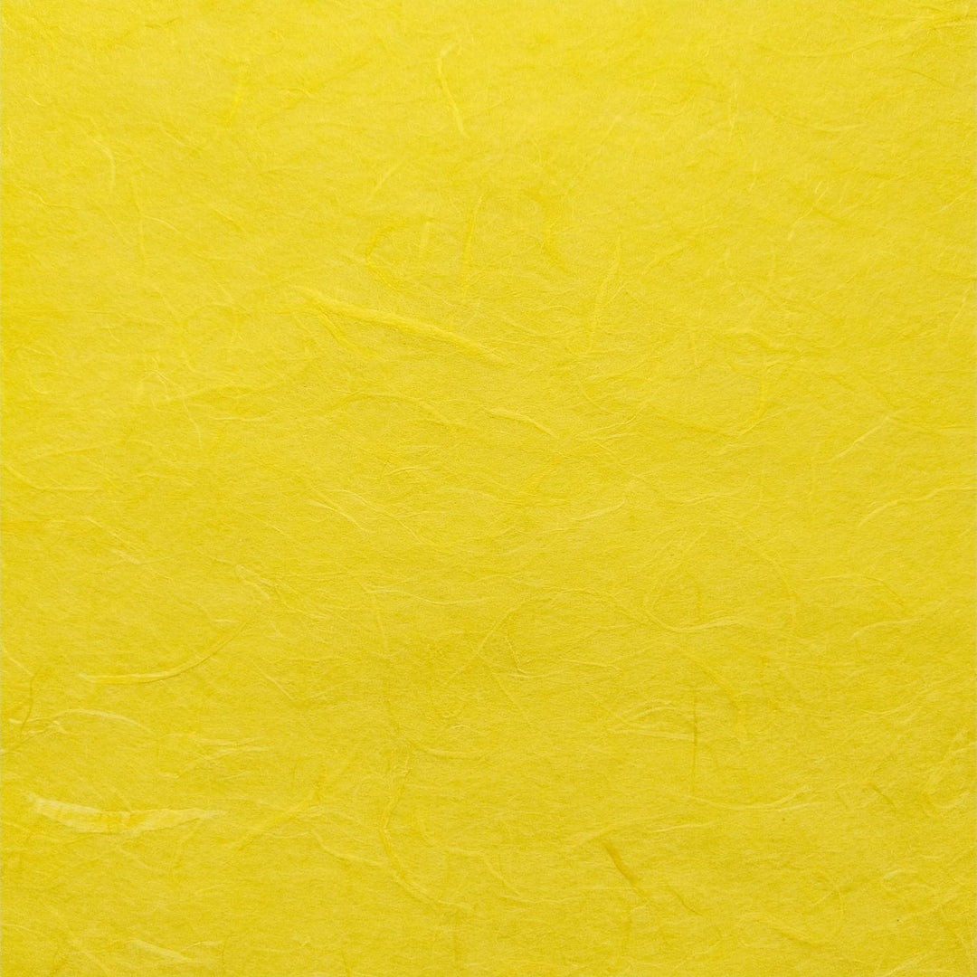 Detailed view of Kozo Studio handmade paper in canary yellow with fibrous mulberry texture and elegant shadows.