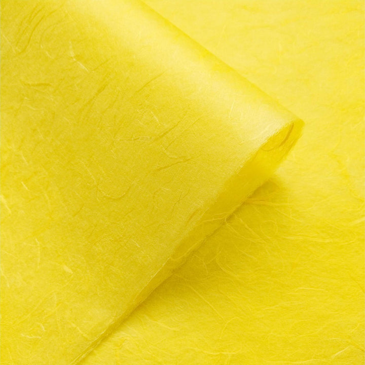 Kozo Studio Unryu paper in bright yellow, crafted from mulberry fibers with visible texture and folded details.