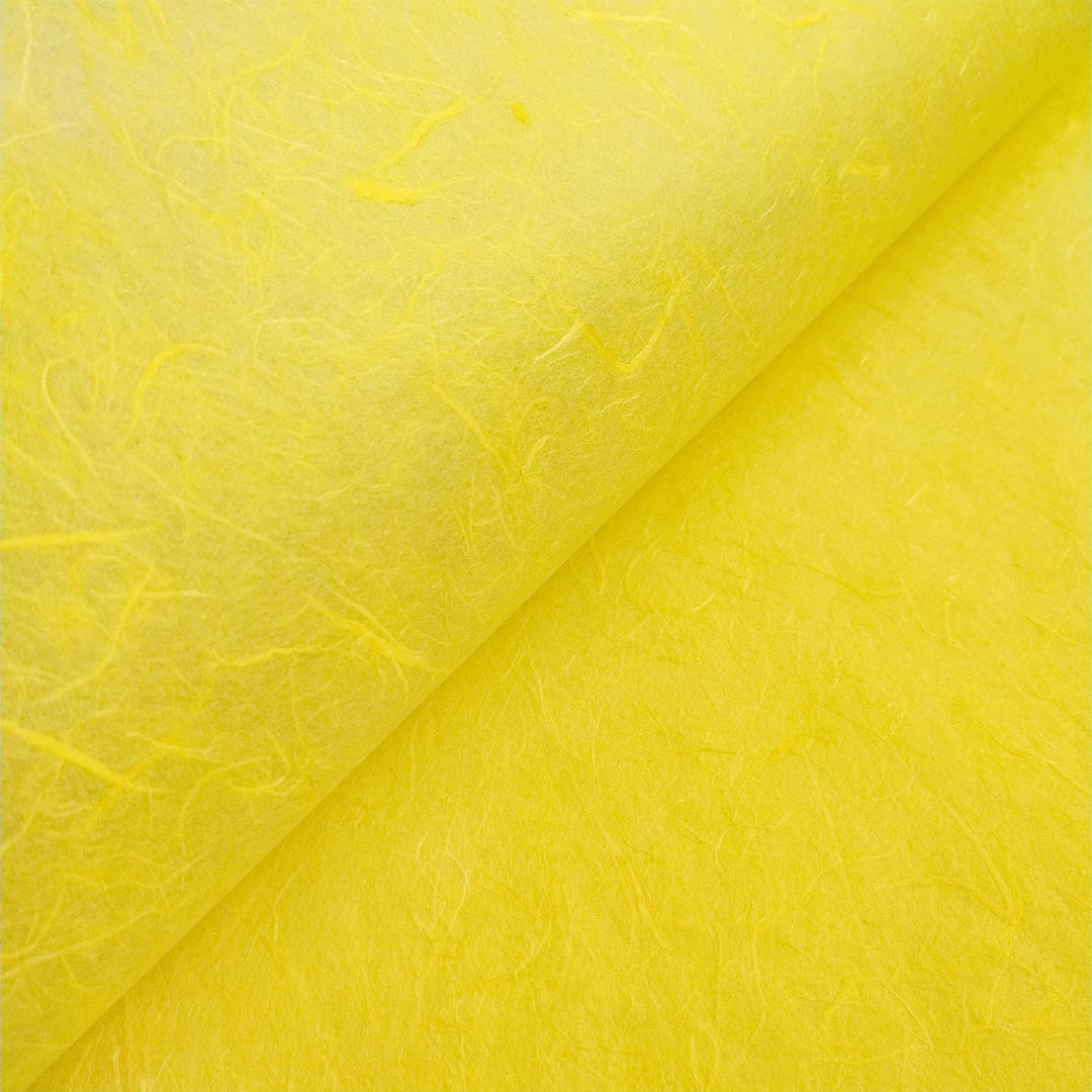 Canary yellow handmade paper by Kozo Studio made from mulberry fibers, showcasing fine lines and natural depth.