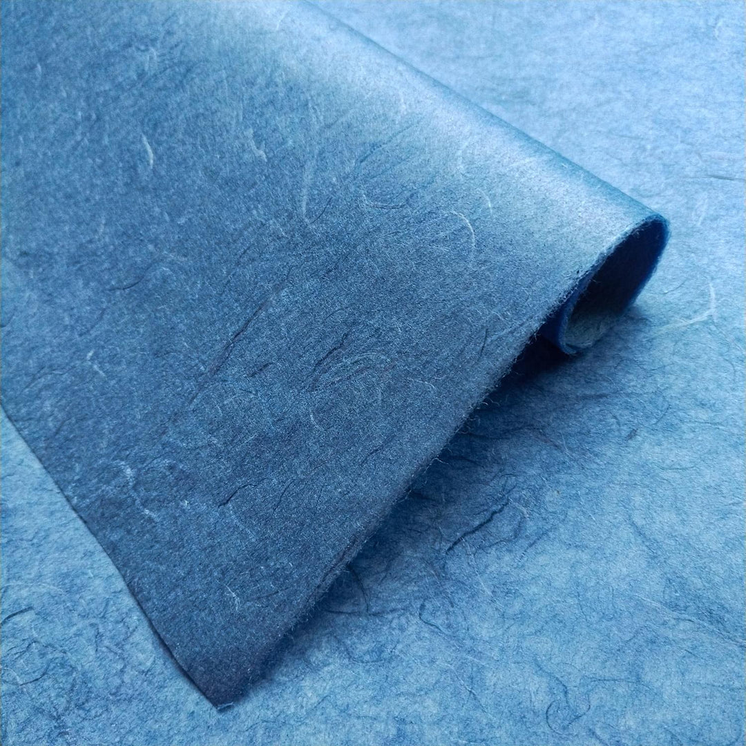 Handmade paper sheets in cobalt blue from Kozo Studio featuring Unryu-style mulberry fibers