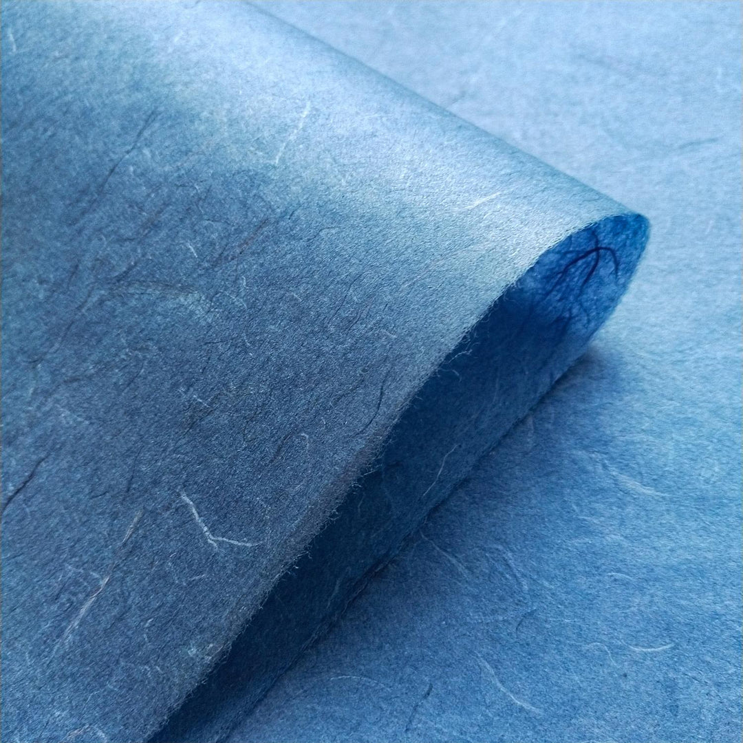 Close-up of Kozo Studio handmade mulberry paper with fibrous Unryu texture in cobalt blue