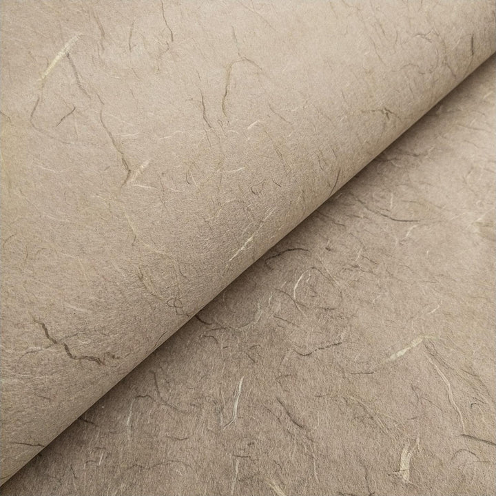 Macro shot of fibrous mulberry paper from Kozo Studio, showcasing handcrafted grey Unryu texture.