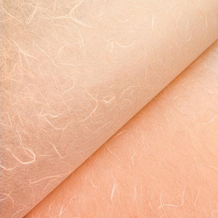 Kozo Studio Unryu paper in salmon orange with characteristic mulberry strands and gentle creases enhancing texture.