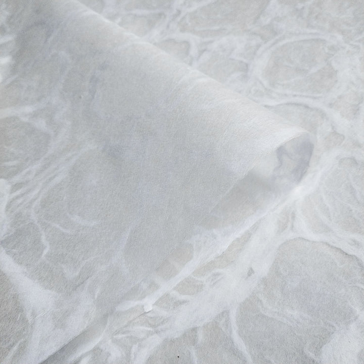 Elegant Ripple Kozo paper with a water ripple effect, made from high-quality mulberry fiber and crafted by Kozo Studio using traditional handmade paper techniques.