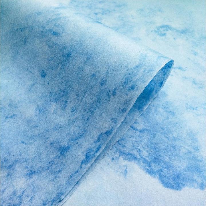 Detailed view of Kozo Studio Sky Kozo Paper Design 1 highlighting the textured surface of blue and white handmade mulberry paper with a soft central curve.