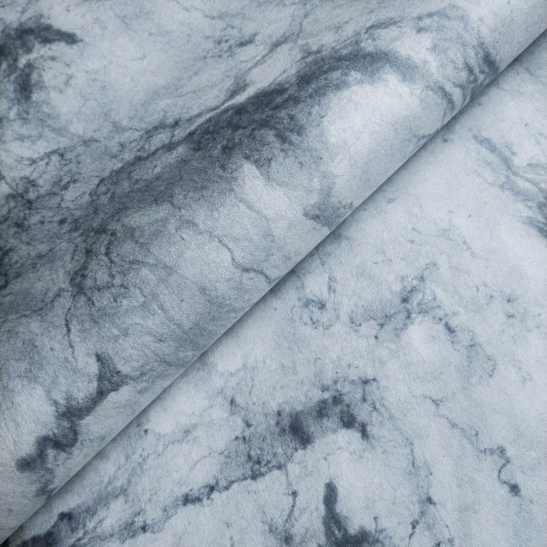 Handmade mulberry paper by Kozo Studio with smooth marbled grey and white textures and swirling patterns resembling natural stone.