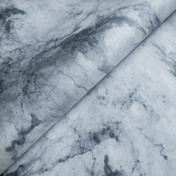 Handmade mulberry paper by Kozo Studio with smooth marbled grey and white textures and swirling patterns resembling natural stone.