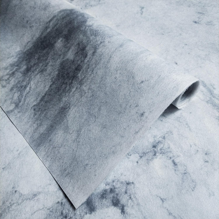 Close-up of Kozo Studio's Sky Kozo Paper Design 2, a handmade mulberry paper with soft marbled textures and artistic grey tones.