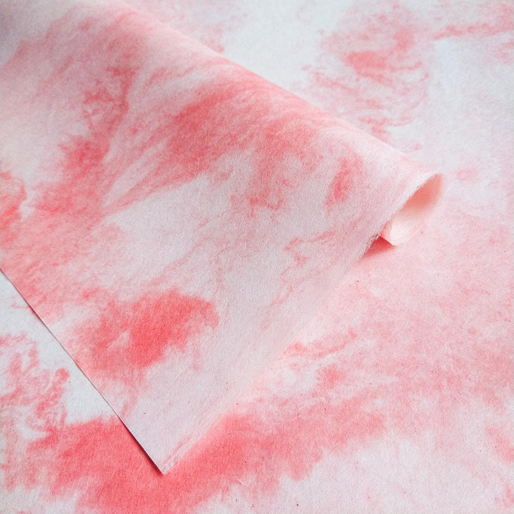 Elegant swirls of pink and white on Sky Kozo Paper by Kozo Studio, highlighting the beauty of handmade mulberry paper.