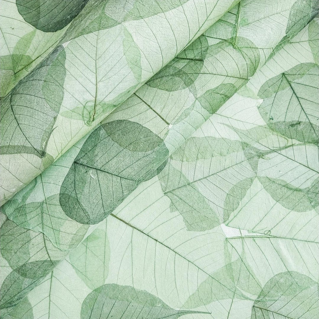 Textured mulberry paper with heart-shaped bodhi leaf designs from Kozo Studio, a durable handmade paper perfect for crafts and decoration.
