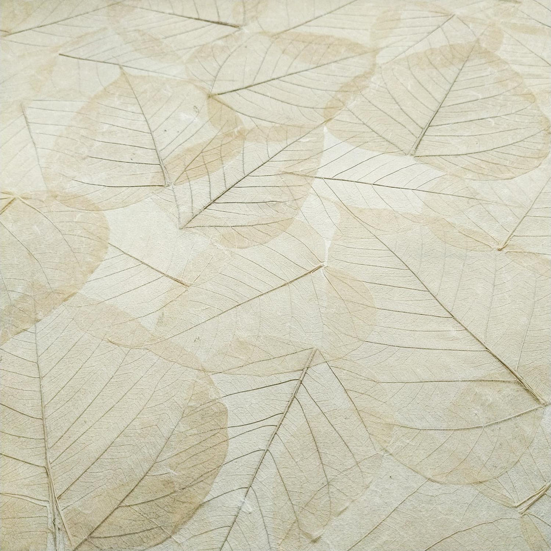 Kozo Studio mulberry paper embellished with skeletonized bodhi leaves, showcasing the craftsmanship of handmade paper perfect for artistic and ornamental use.