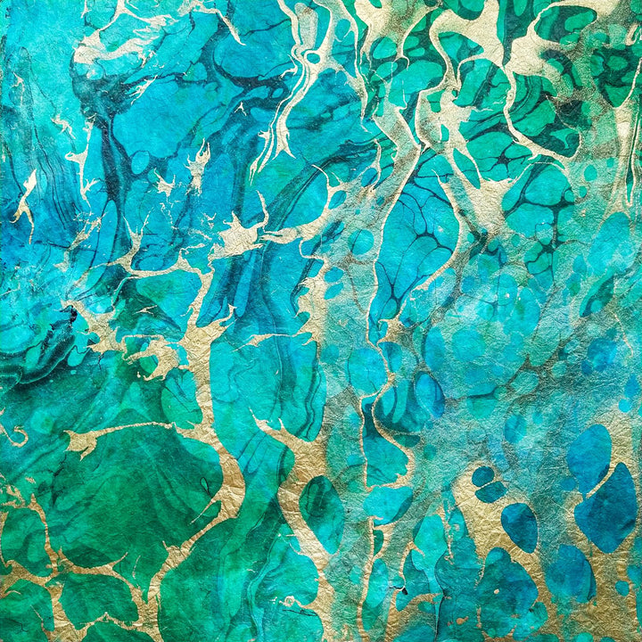 Close-up of Milano Kozo handmade paper with layered mulberry fibers and colorful marbled swirls, perfect for intricate art projects.