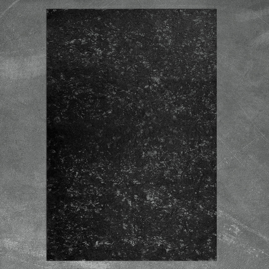 Delicate and strong handmade mulberry paper with natural fiber accents, glowing softly with filtered light—crafted by Kozo Studio for artistic use.