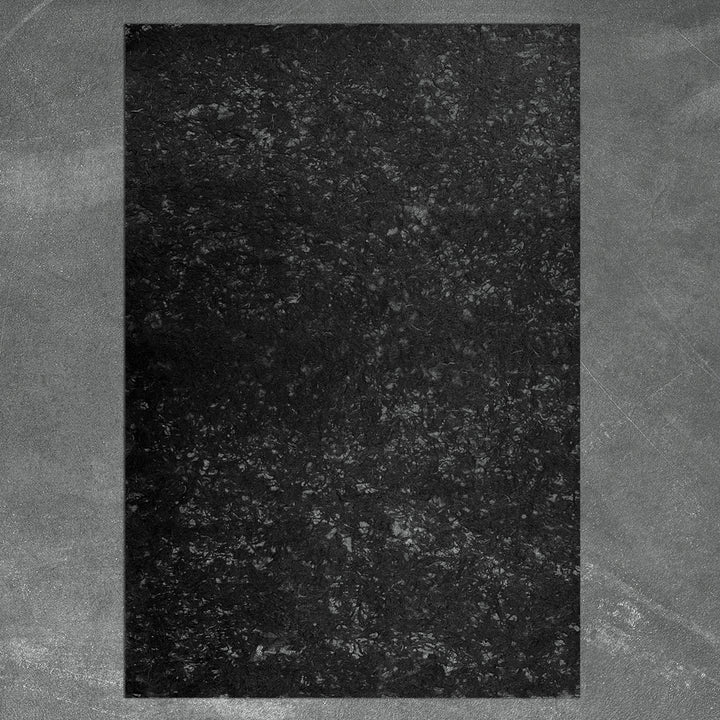 Delicate and strong handmade mulberry paper with natural fiber accents, glowing softly with filtered light—crafted by Kozo Studio for artistic use.