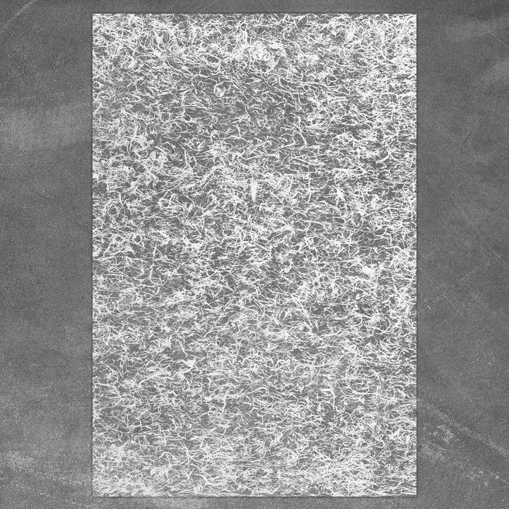 Ethereal mulberry paper by Kozo Studio featuring a super-thin base and scattered fibers, perfect for lampshades, window coverings, and mixed media art.