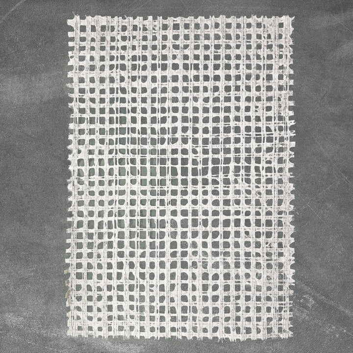 Artisan-made white handmade paper from Kozo Studio, featuring a detailed glen plaid design on high-quality mulberry paper.