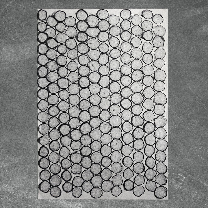 Organic and abstract design on handmade paper from Kozo Studio, featuring a beehive-inspired circle motif with black edges on delicate mulberry paper.