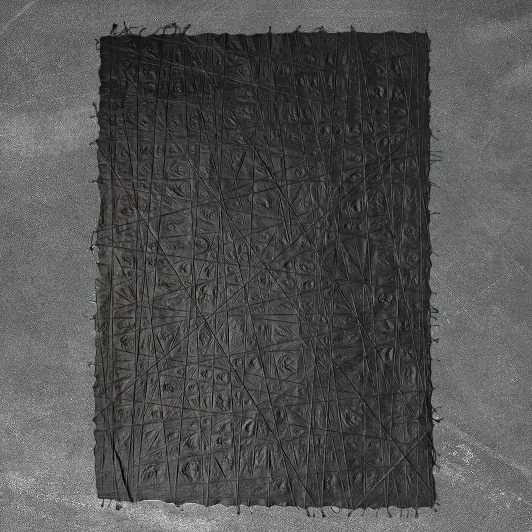 Artistic sheet of handmade kozo paper from Kozo Studio, made with mulberry pulp and detailed with randomly threaded cotton lines creating a textured black surface.