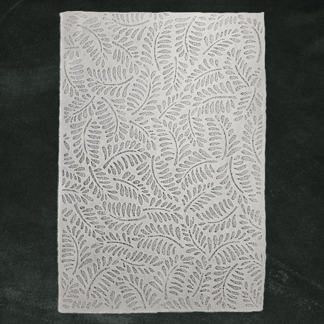 Translucent handmade paper featuring intricate fern designs made with water-displacement at Kozo Studio, perfect for crafts and interior decor.