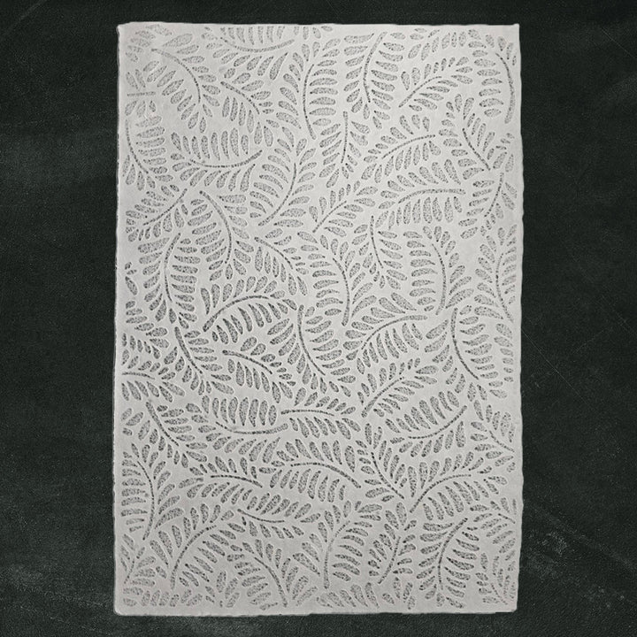 Translucent handmade paper featuring intricate fern designs made with water-displacement at Kozo Studio, perfect for crafts and interior decor.