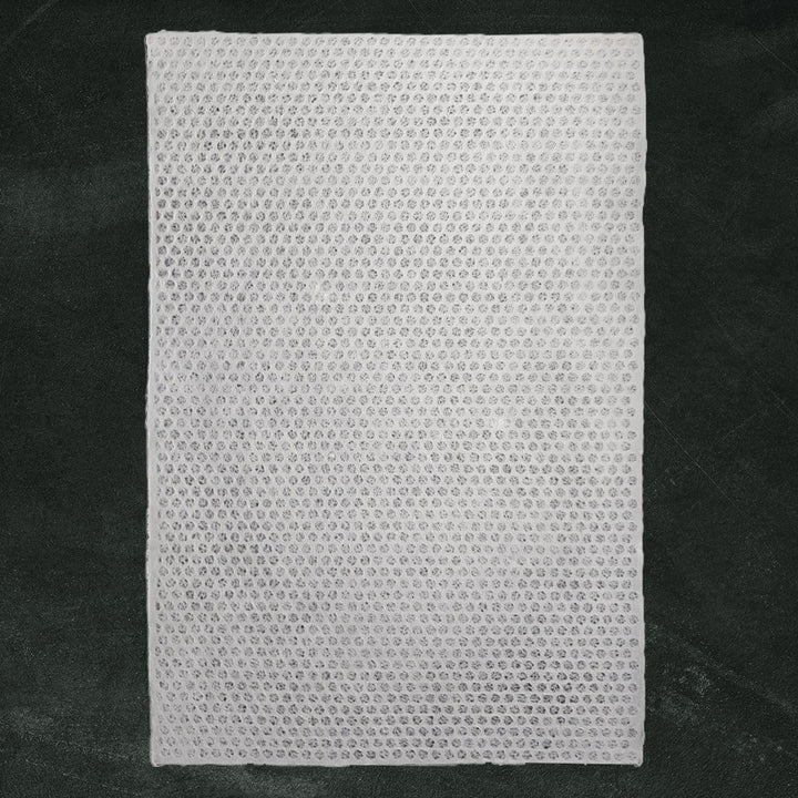 Translucent handmade kozo paper showcasing a delicate polkadot lace design, ideal for lampshades and window decor from Kozo Studio.