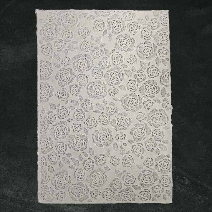 Intricate white lace-like texture on mulberry paper, crafted by Kozo Studio, perfect for lampshades, window art, or elegant fashion projects.