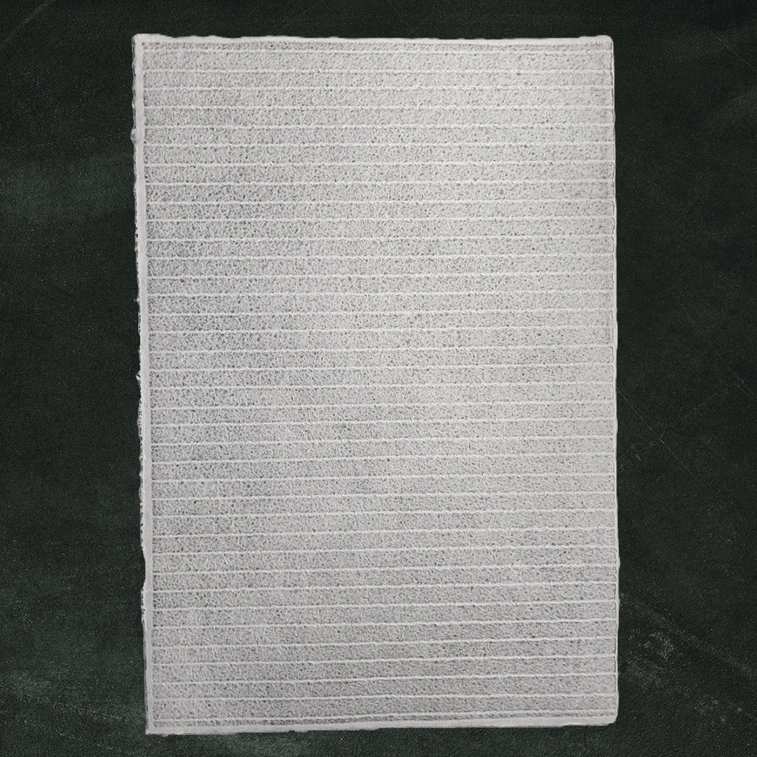 Textured white handmade paper created by Kozo Studio, featuring intricate lace stripes made from mulberry pulp with the Rakusui water-displacement method for unique design and transparency.