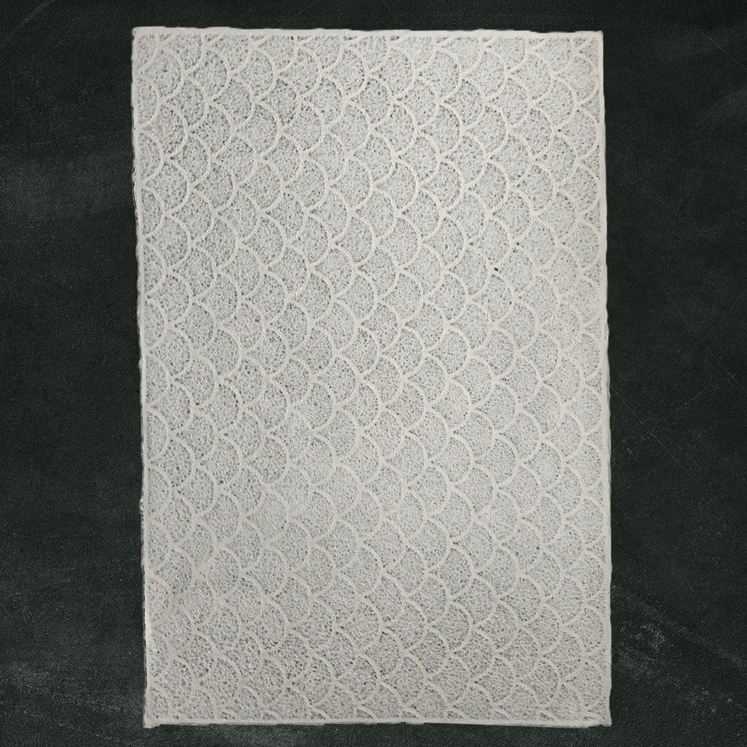 Handmade paper from Kozo Studio featuring lace-like wave texture on mulberry paper, ideal for lampshades, window coverings, and creative crafts.