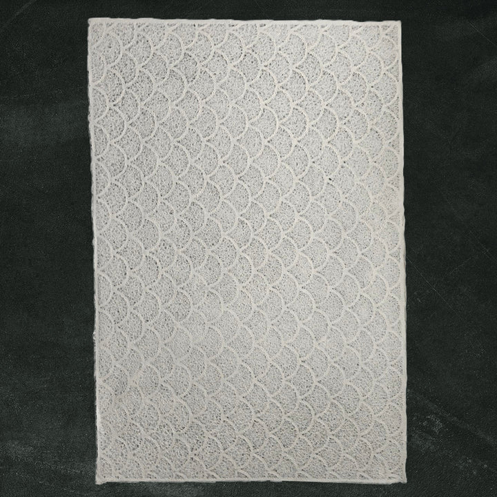 Handmade paper from Kozo Studio featuring lace-like wave texture on mulberry paper, ideal for lampshades, window coverings, and creative crafts.