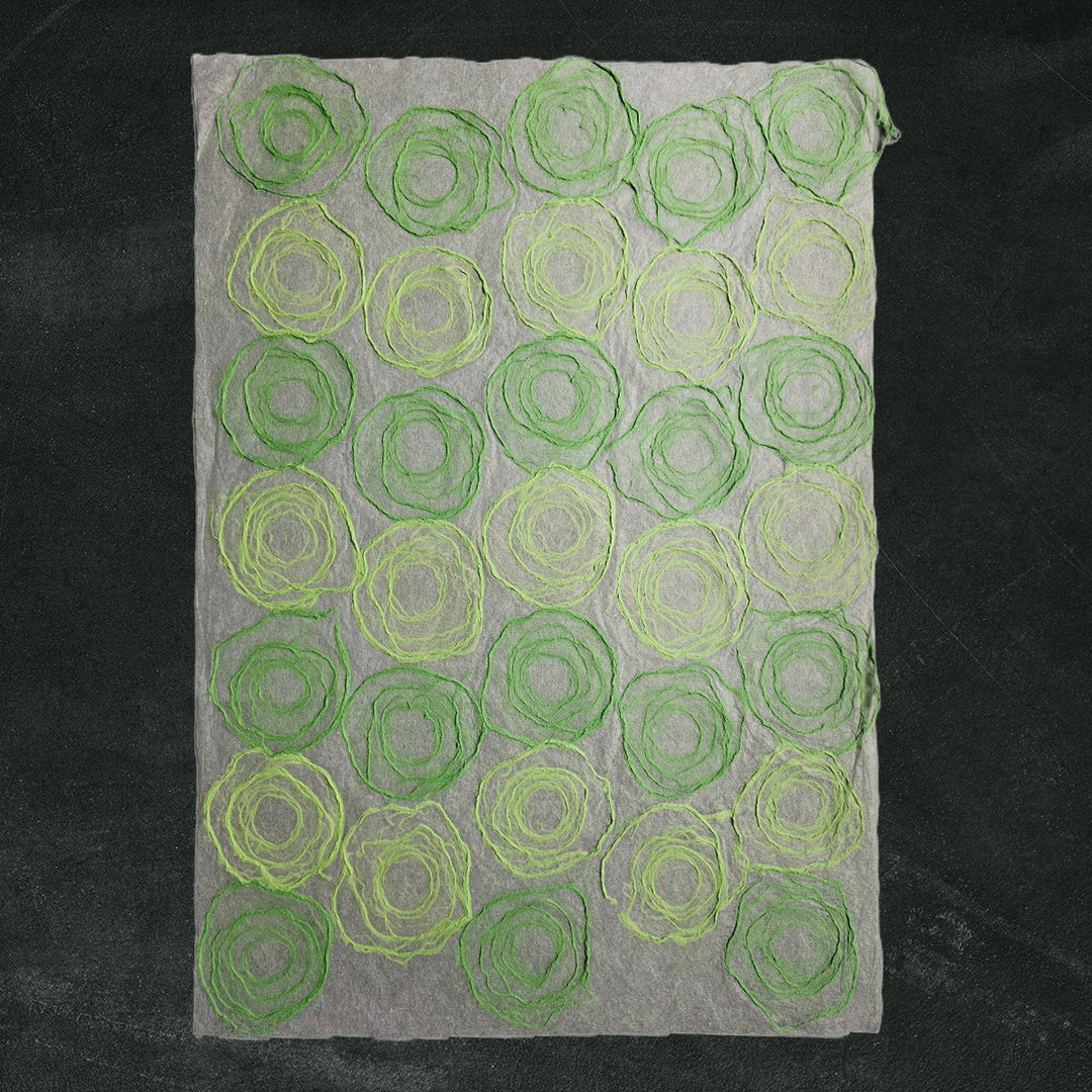 Translucent handmade paper crafted from mulberry fibers by Kozo Studio, showcasing a green and light green rose pattern perfect for art, decor, and paper crafts.