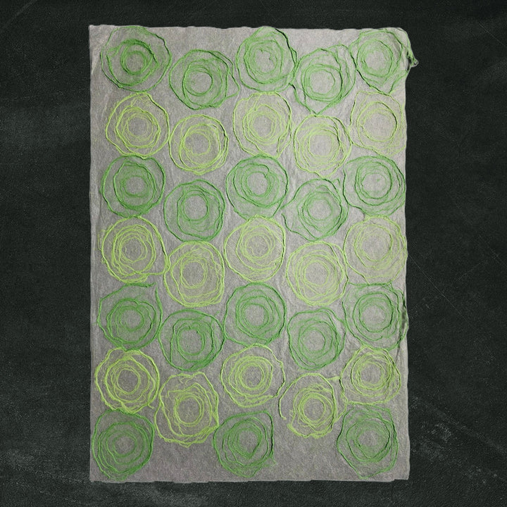 Translucent handmade paper crafted from mulberry fibers by Kozo Studio, showcasing a green and light green rose pattern perfect for art, decor, and paper crafts.