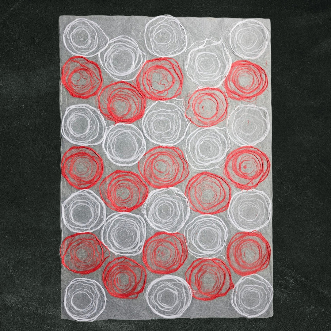 Elegant handmade paper featuring red and white rose designs on translucent mulberry paper, created by Kozo Studio for artistic use.