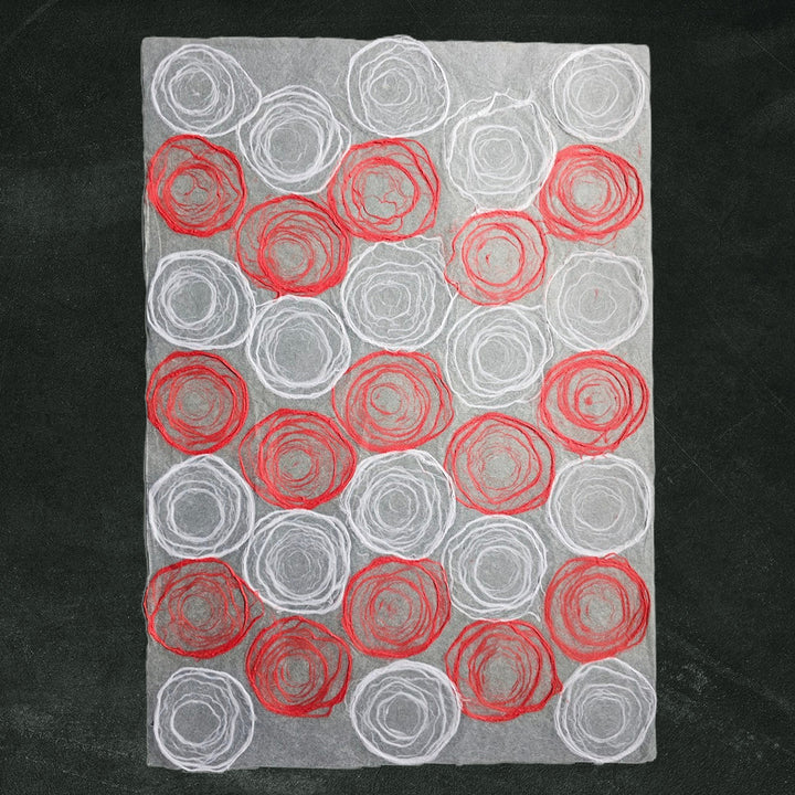 Elegant handmade paper featuring red and white rose designs on translucent mulberry paper, created by Kozo Studio for artistic use.