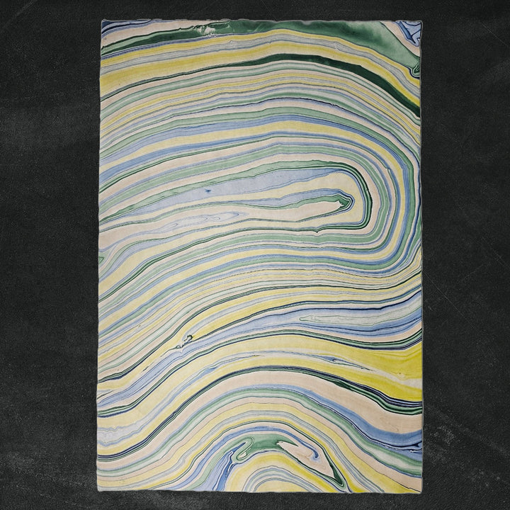 Marble Kozo Paper Design 3 by Kozo Studio, showcasing handmade mulberry paper with a flowing geometric pattern in vibrant yellow, green, blue, and cream hues. Ideal for art, crafts, and decor.