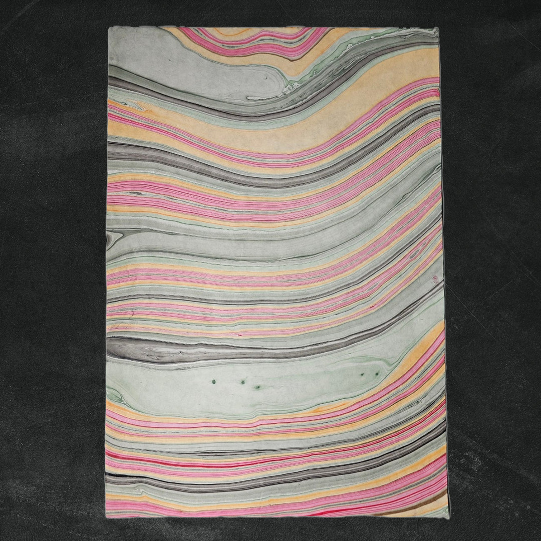 Detailed image of Marble Kozo Paper by Kozo Studio, a vibrant handmade paper with swirling oil patterns resembling traditional mulberry paper.