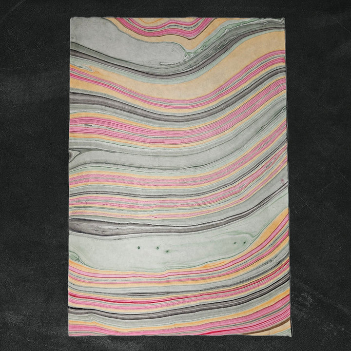 Detailed image of Marble Kozo Paper by Kozo Studio, a vibrant handmade paper with swirling oil patterns resembling traditional mulberry paper.
