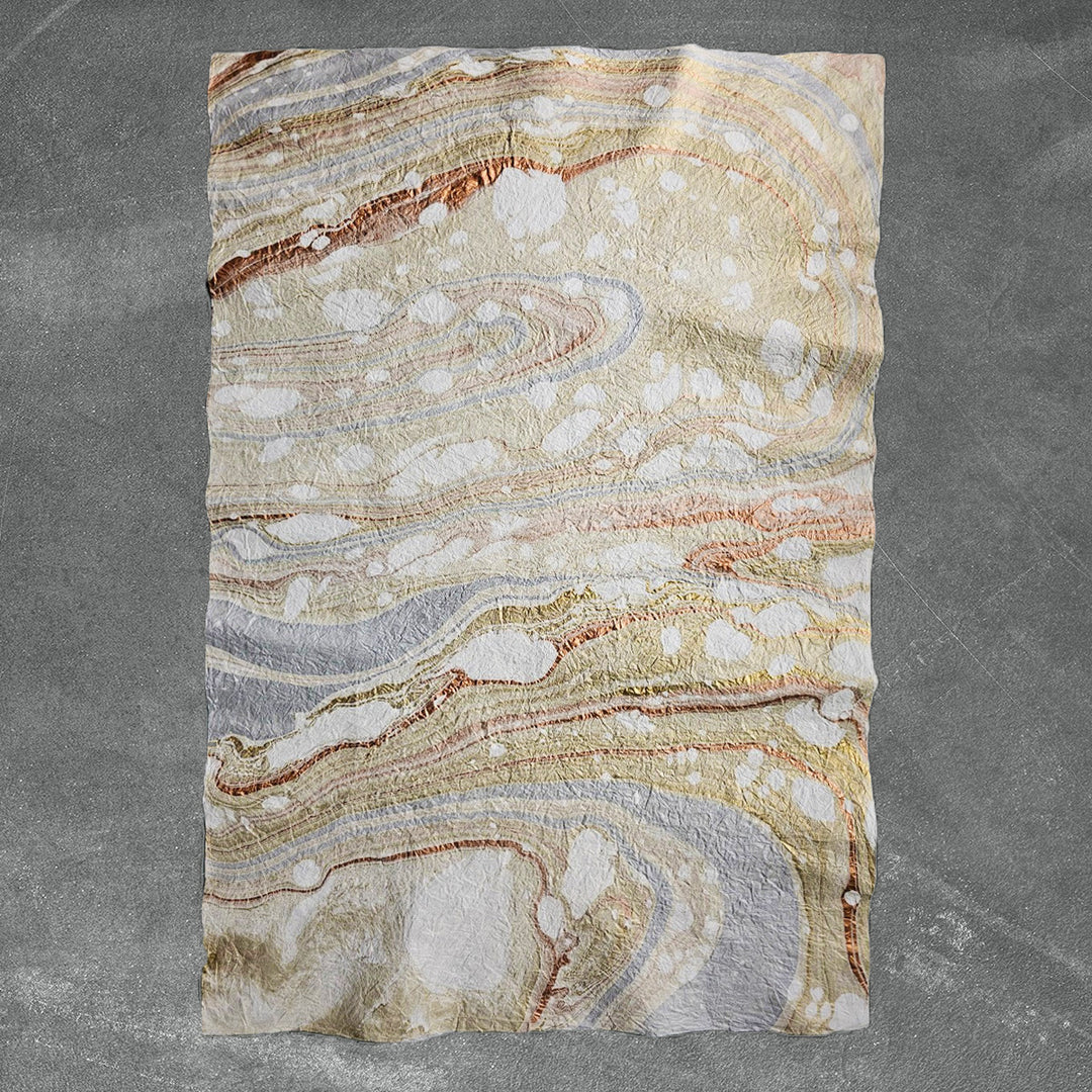 Artistic sheet of handmade paper from Kozo Studio featuring Milano Kozo Paper – Design 10, created by layering mulberry paper over oil-based swirls for a one-of-a-kind look.