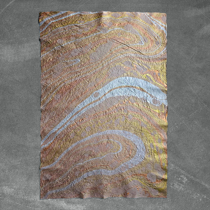 Handcrafted mulberry paper in taupe from Kozo Studio, showcasing a unique marbled design and crinkled texture perfect for fine art and craft projects.