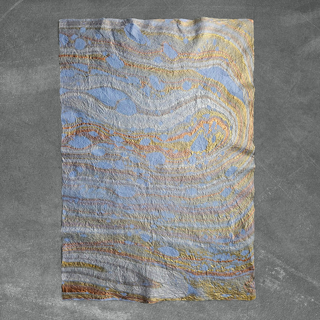 Kozo Studio's Design 13 light blue handmade paper with swirling marbled patterns on premium mulberry paper for art and crafts.