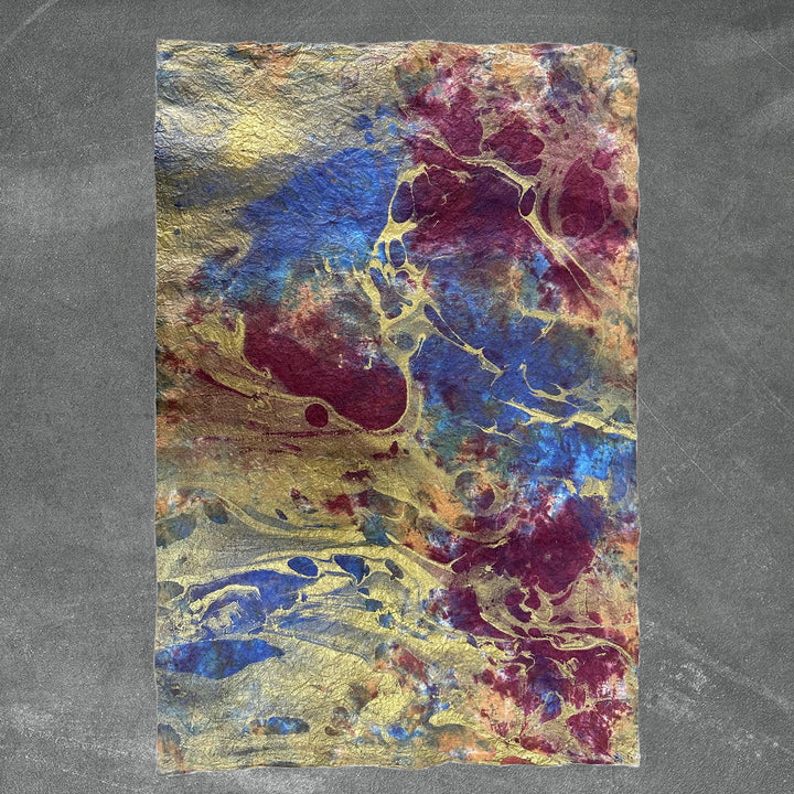 Detail shot of Kozo Studio's Milano Design 6 handmade paper, showcasing vibrant oil-based marbling layered over delicate mulberry paper with a soft, fabric-like texture.